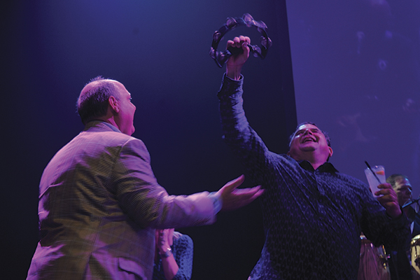 Taylor and Doug Pitassi, President, Pacific Office Automation, help bring the house down during the band's encore.